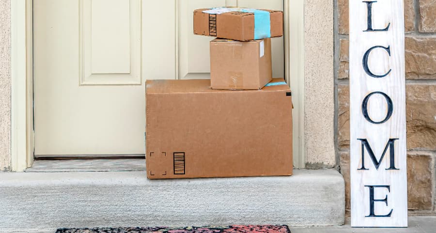 Deliveries on the front porch of a house with a welcome sign in Topeka